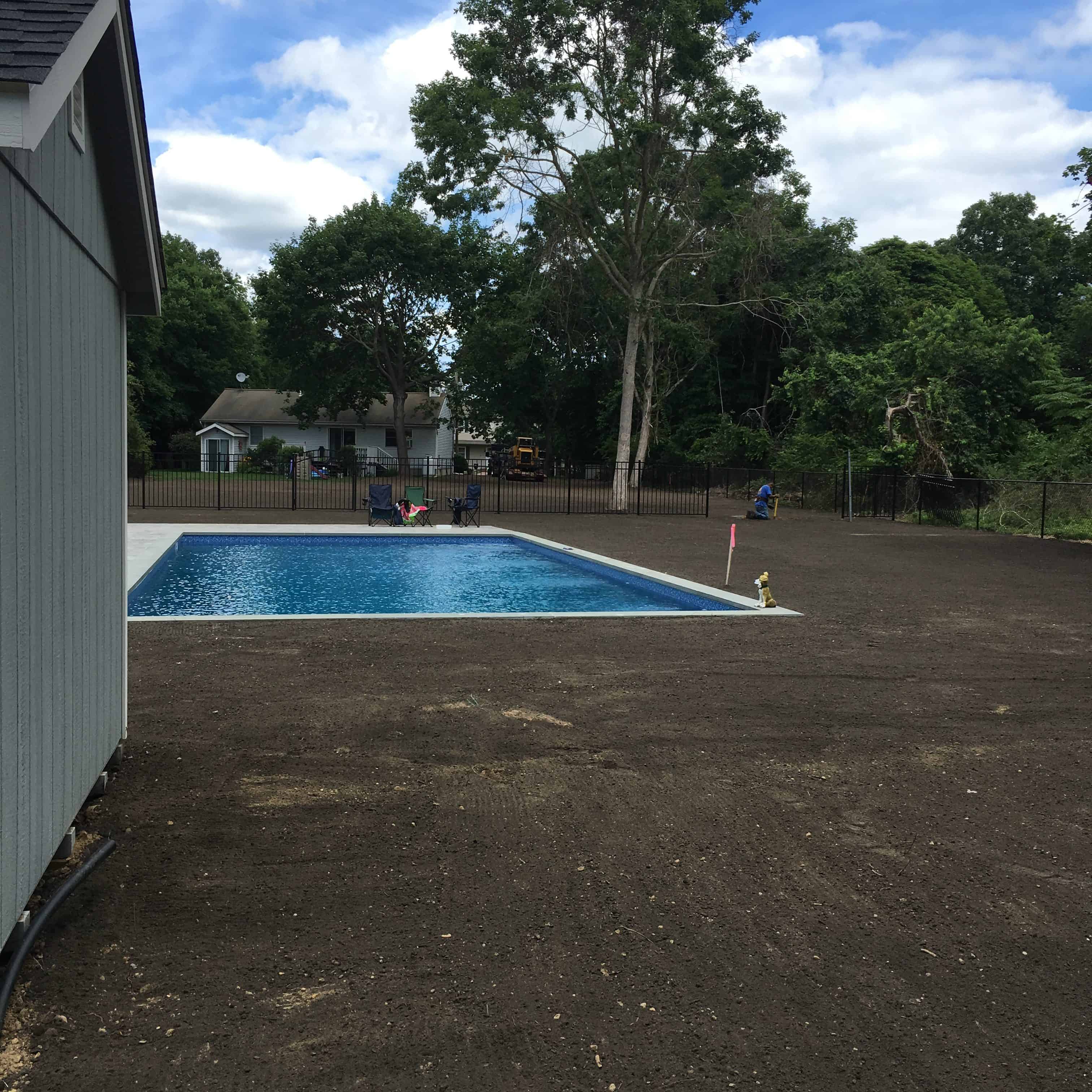 pool in graded backyard with new soil